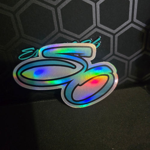 Holographic sticker with colorful design on a dark textured background